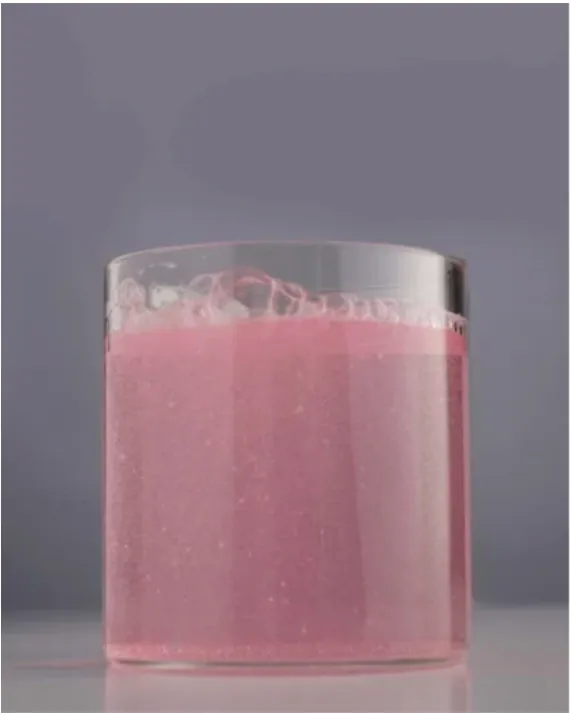 A glass of pink JUJU collagen drink ready to enjoy