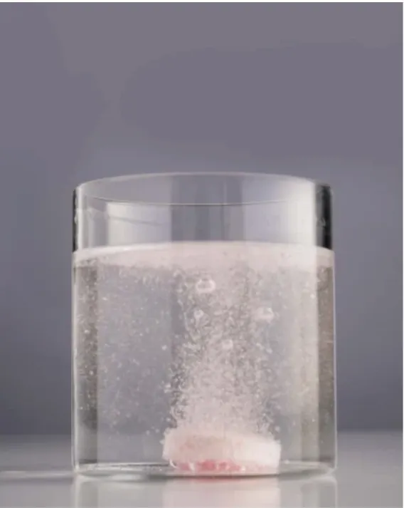 The JUJU tablet fizzing and dissolving in the glass