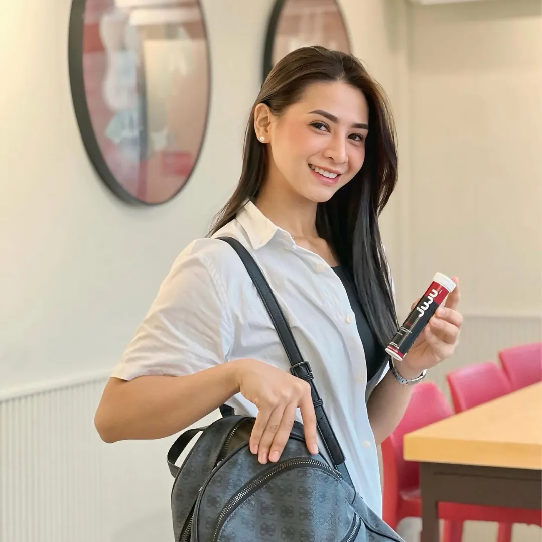 Woman on the go holding a JUJU collagen tube