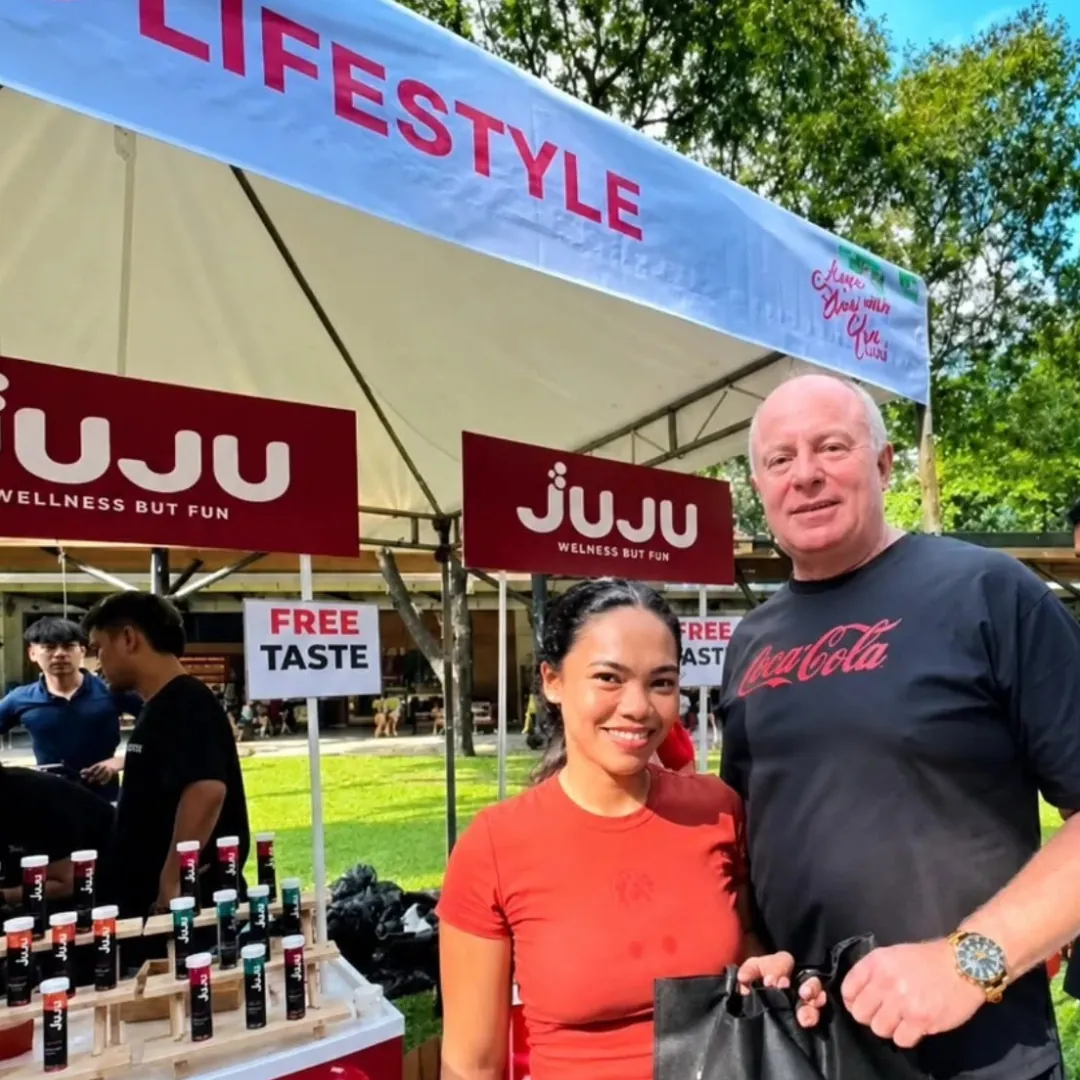 JUJU free-taste booth at a lifestyle event with tubes on display
